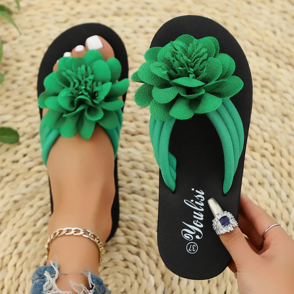 Casual beige flip-flops with a floral pattern on the straps and a light-coloured EVA sole.
