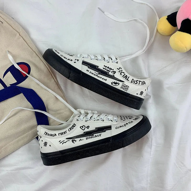 Women's white canvas shoes low top with lace-up tie and graffiti pattern on non-slip vulcanised sole