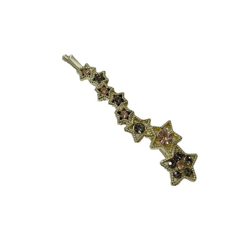 Gold alloy rhinestone barrette with a side clip, star decoration, and text.