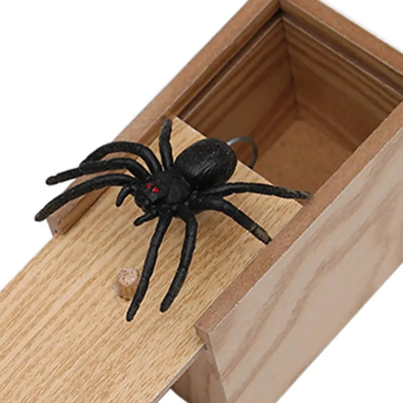 Wooden prank scare box closed on table, with random jumping animal surprise inside for April Fools' tricks.