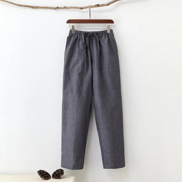 Men's solid colour cotton casual trousers with belt in beige, showing mid waist and drawstring design