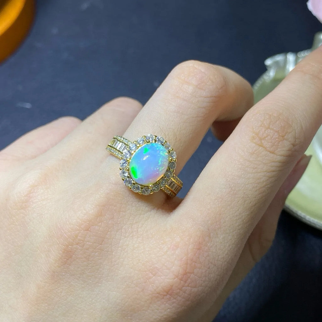 Handmade adjustable opal ring on a sterling silver open band with gold tone plating.
