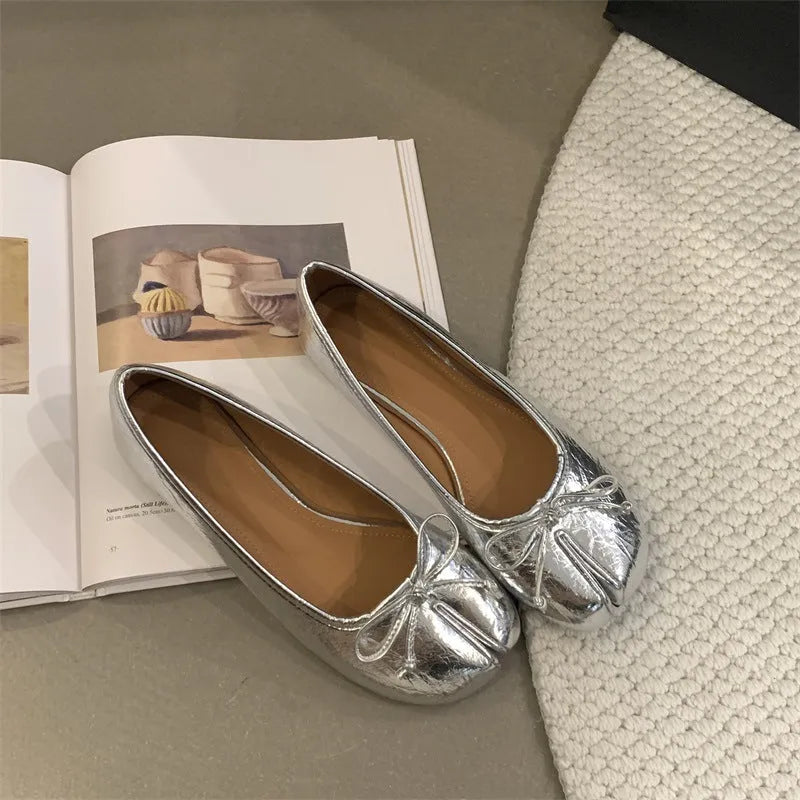 Women's split-toe flats in beige colour showing round toe design and slip-on style with shallow vamp cut