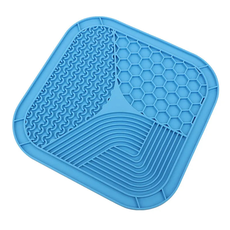 Gray silicone anti-choke slow feeding dog licking pad with textured surface on a flat surface