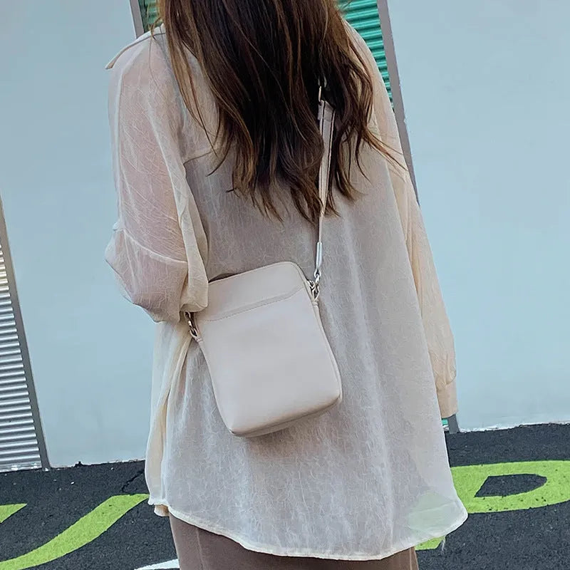 Solid colour PU leather crossbody phone bag in beige, shown with strap.