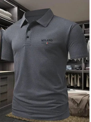 Man wearing a solid colour short-sleeved polo shirt with a formal lapel collar, loose fit.