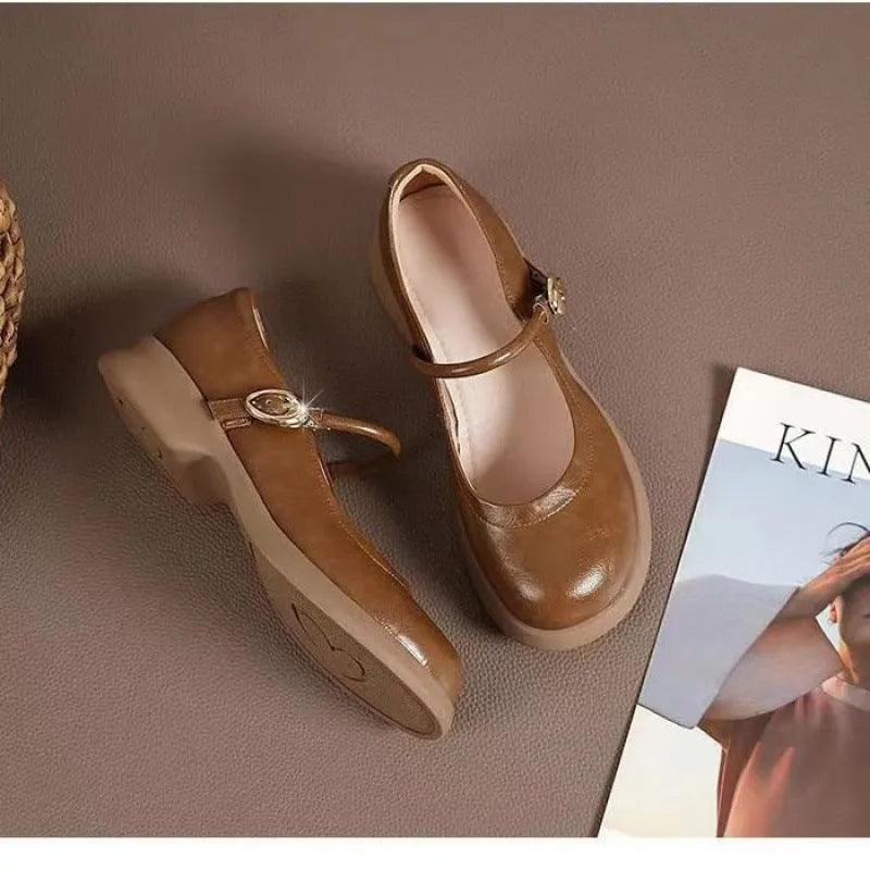 Flat black cheongsam leather shoes with a white skull pattern on the toe and a light brown wedge heel.