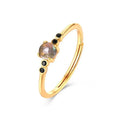 Gold coloured open ring with geometric round shape on silver base with electroplating