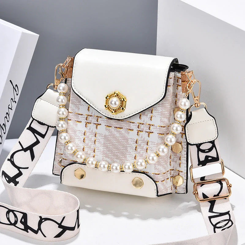 Stylish crossbody bag with pearl chain, made of durable PU leather and available in multiple colors