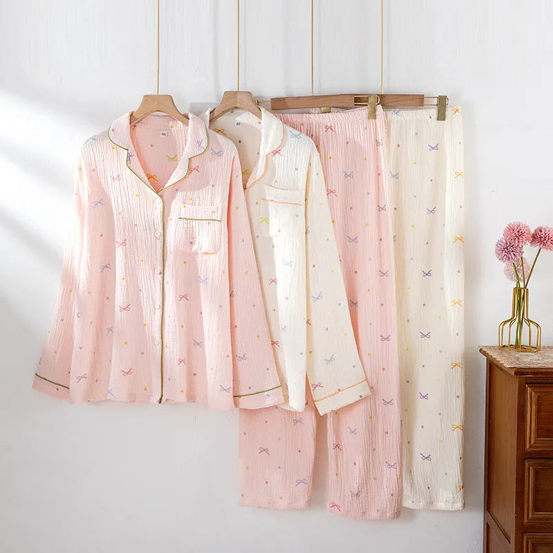 Beige and pink women's long-sleeved cotton pajama set with trousers on hanger.
