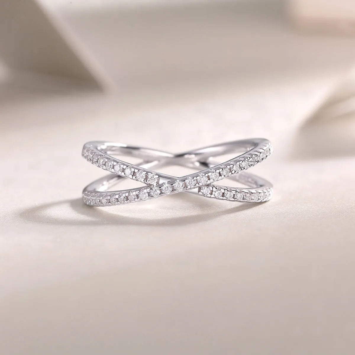 Love Interwoven moissanite wedding ring set in gold finish, S925 silver platinum plated, on white background with gift box.