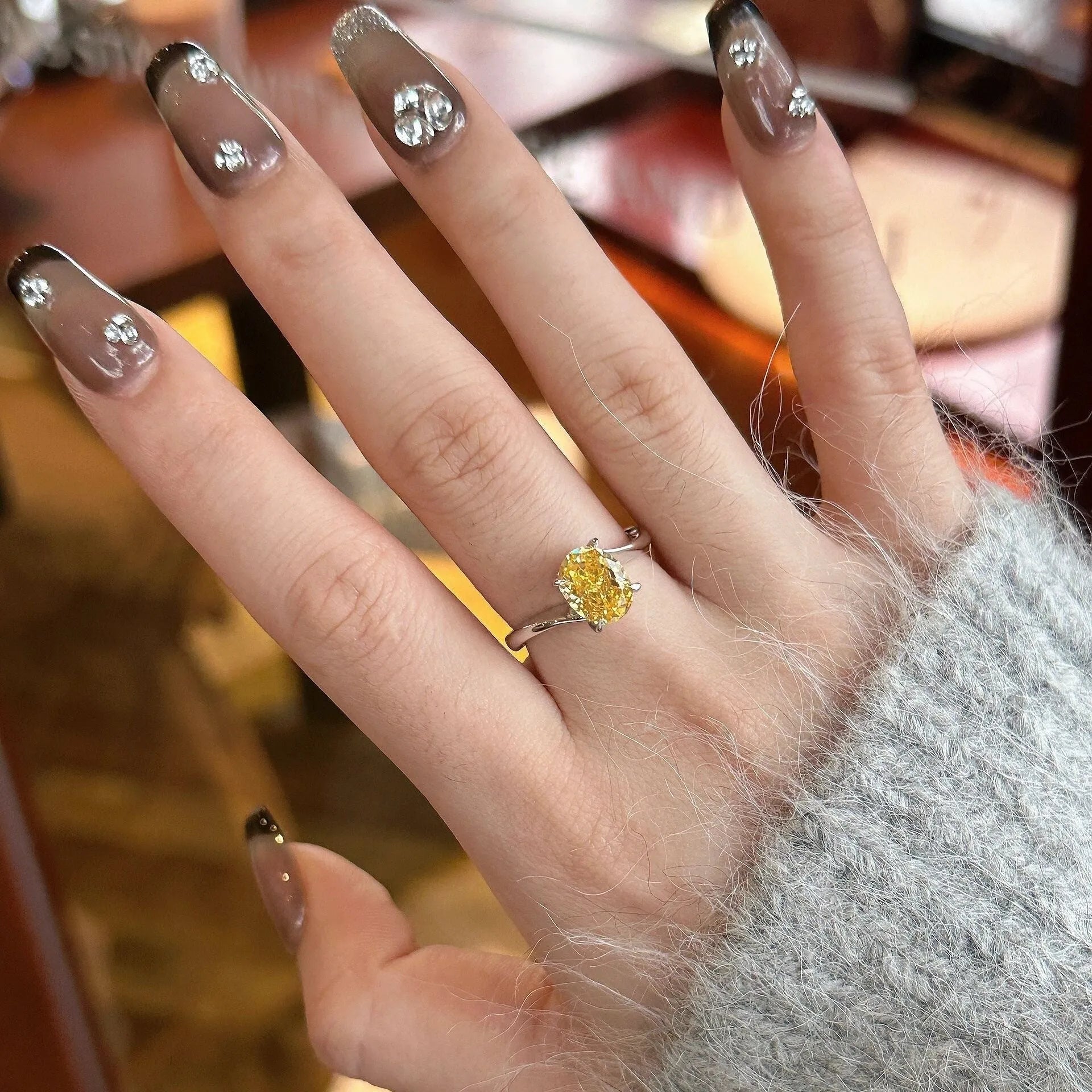 Yellow rock sugar crystal colour copper ring for women on a ring stand.