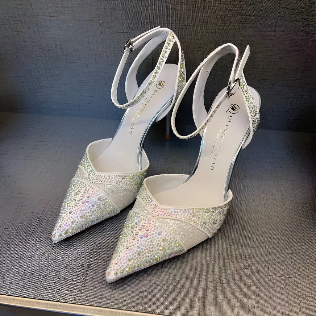 Women's black hollow stiletto heel pump shoe with pointed toe and red sole on a white background.