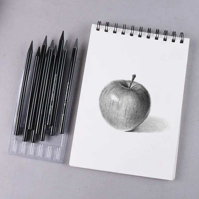 Set of graphite and carbonized drawing pencils with wooden barrels on suction card packaging
