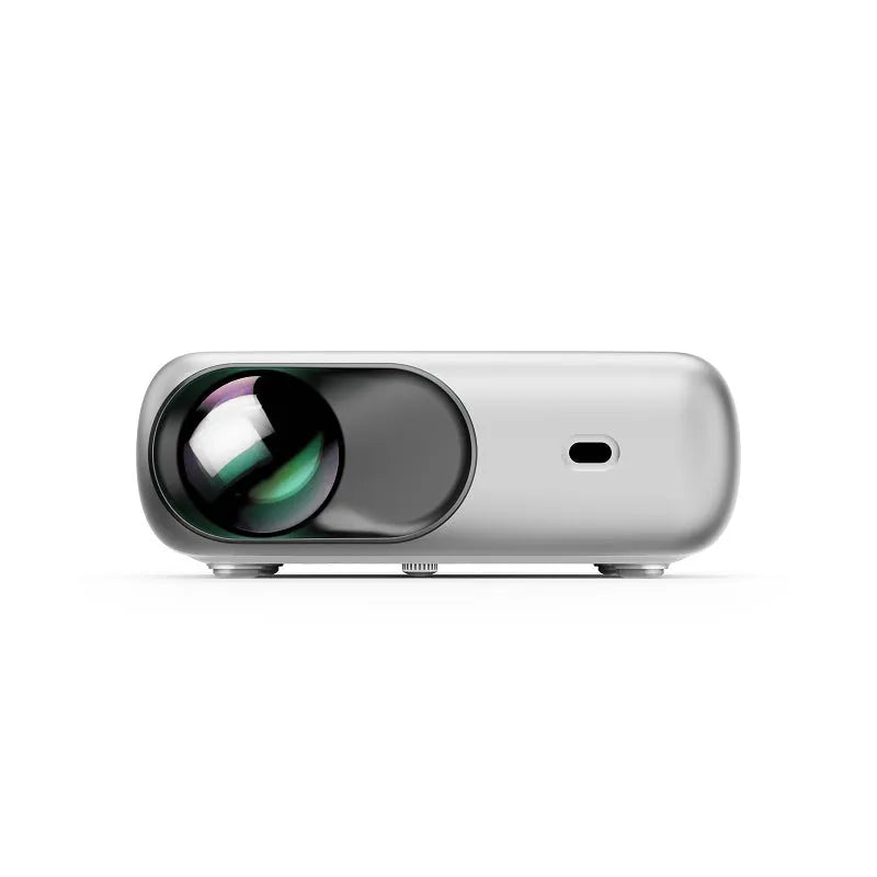 White portable WiFi HD 1080p projector with focus ring and remote control on a table