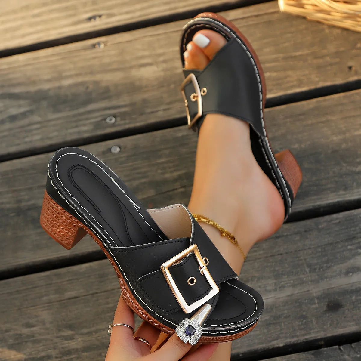 Women's black retro chunky heel slippers with a silver metal buckle on the strap.