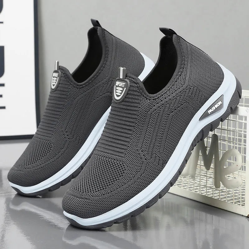 Men's grey breathable casual slip-on shoes with mesh detailing and a round toe.