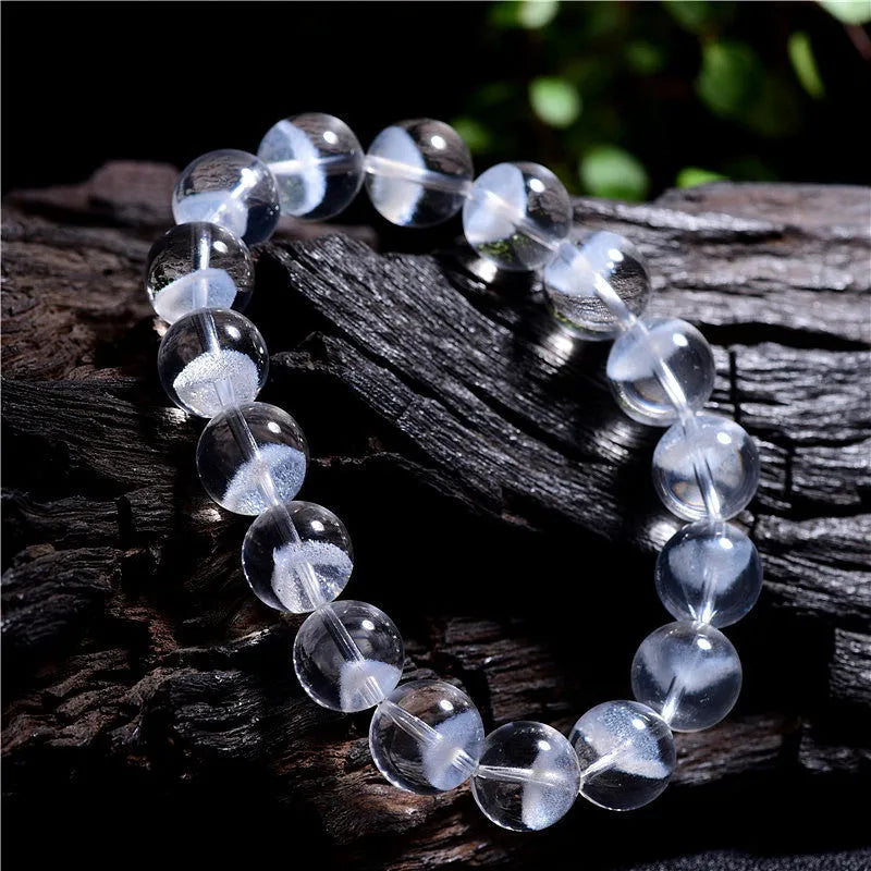 Women's adjustable white crystal bracelet with a pyramid bead and ruyi charm, shown on a wrist.