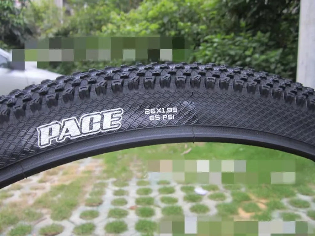 Ultralight puncture-proof mountain bike tyre in multiple sizes on a grey background.