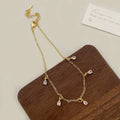 Women's zircon necklace, earrings, and anklet set with geometric meteor shower design.
