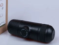 Black portable manual espresso maker showing compact 17.5cm height and 6cm diameter.