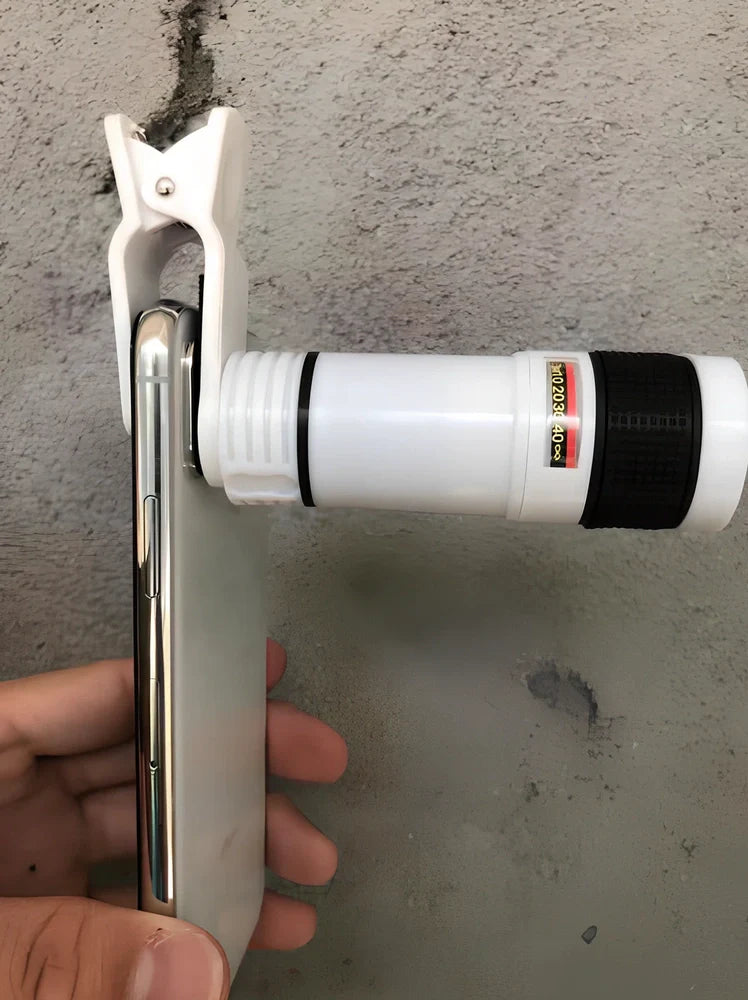 Clip-on 12x zoom telescope lens attached to Galaxy S7 phone, showing retractable design and universal clip, 80x30mm size