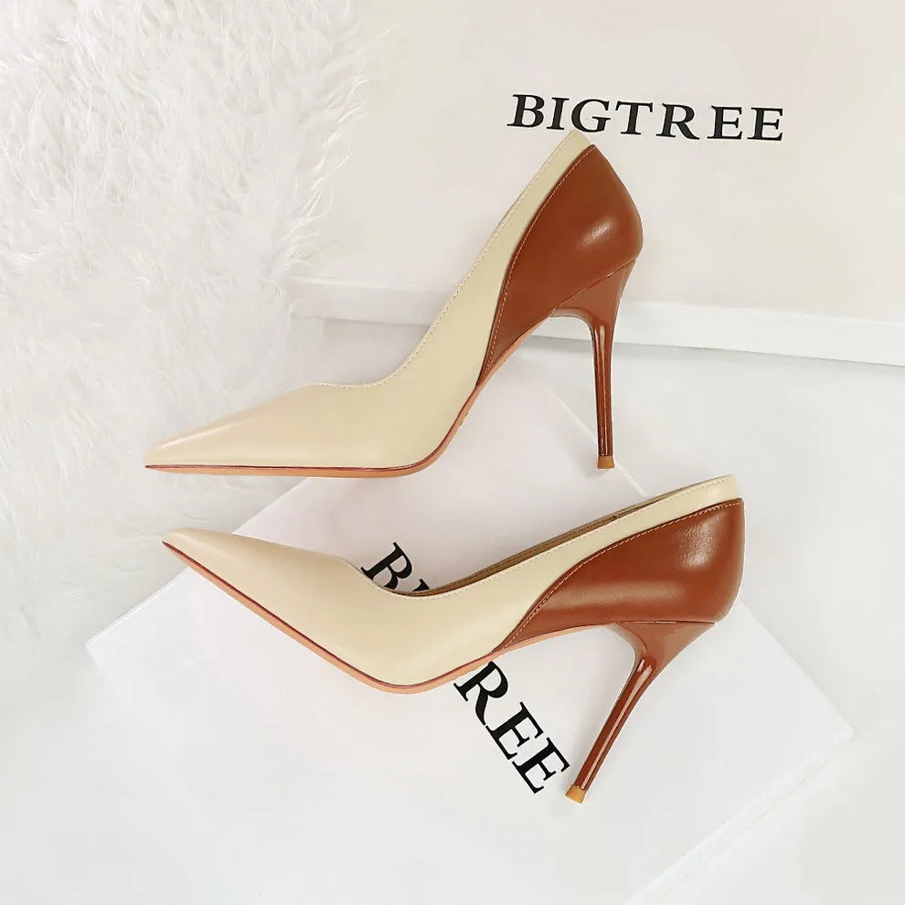 Women's black retro pumps with a pointed toe and high stiletto heel on a white background.