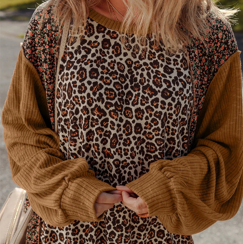 Women's leopard print loose sweater with 100% polyester construction, available in four UK sizes from S to XL, featuring long sleeves and hollow knit design for versatile layering options