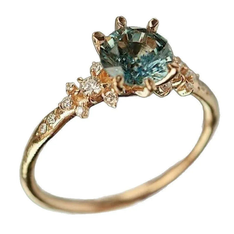 Gold plated geometric claw ring with zircon inlay on a chamfered square pattern design.