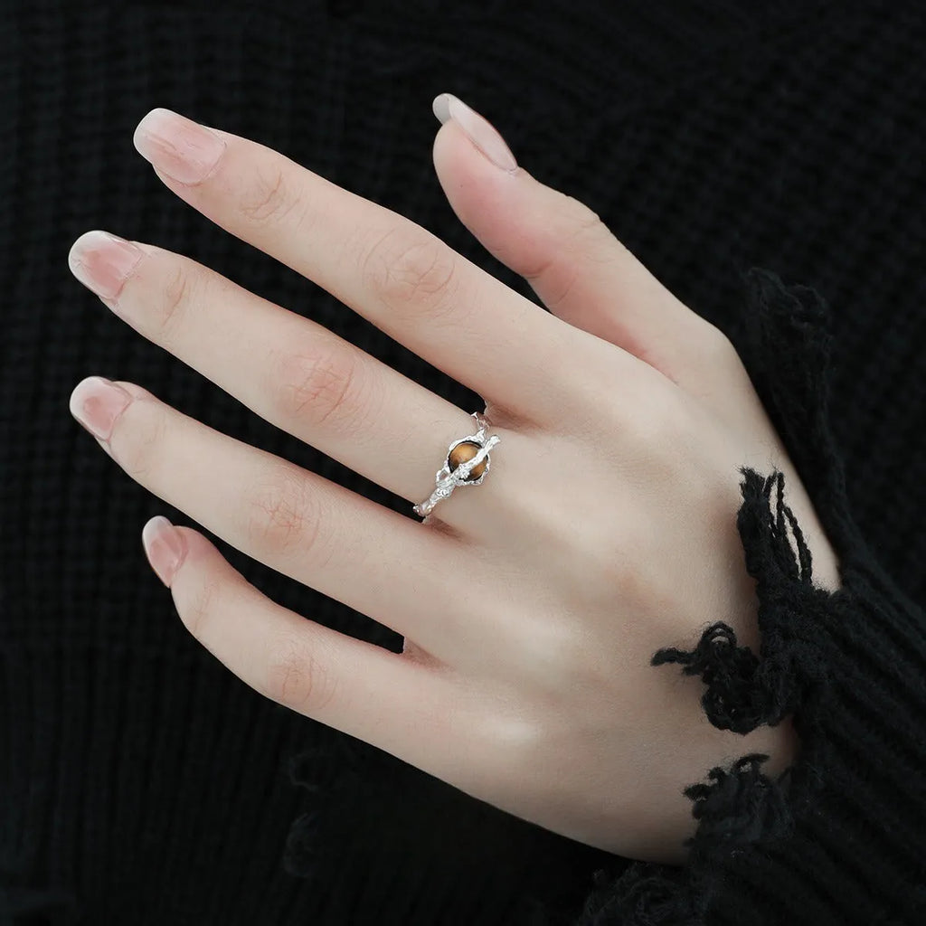 White gold colour Saturn open ring with adjustable opening on silver background