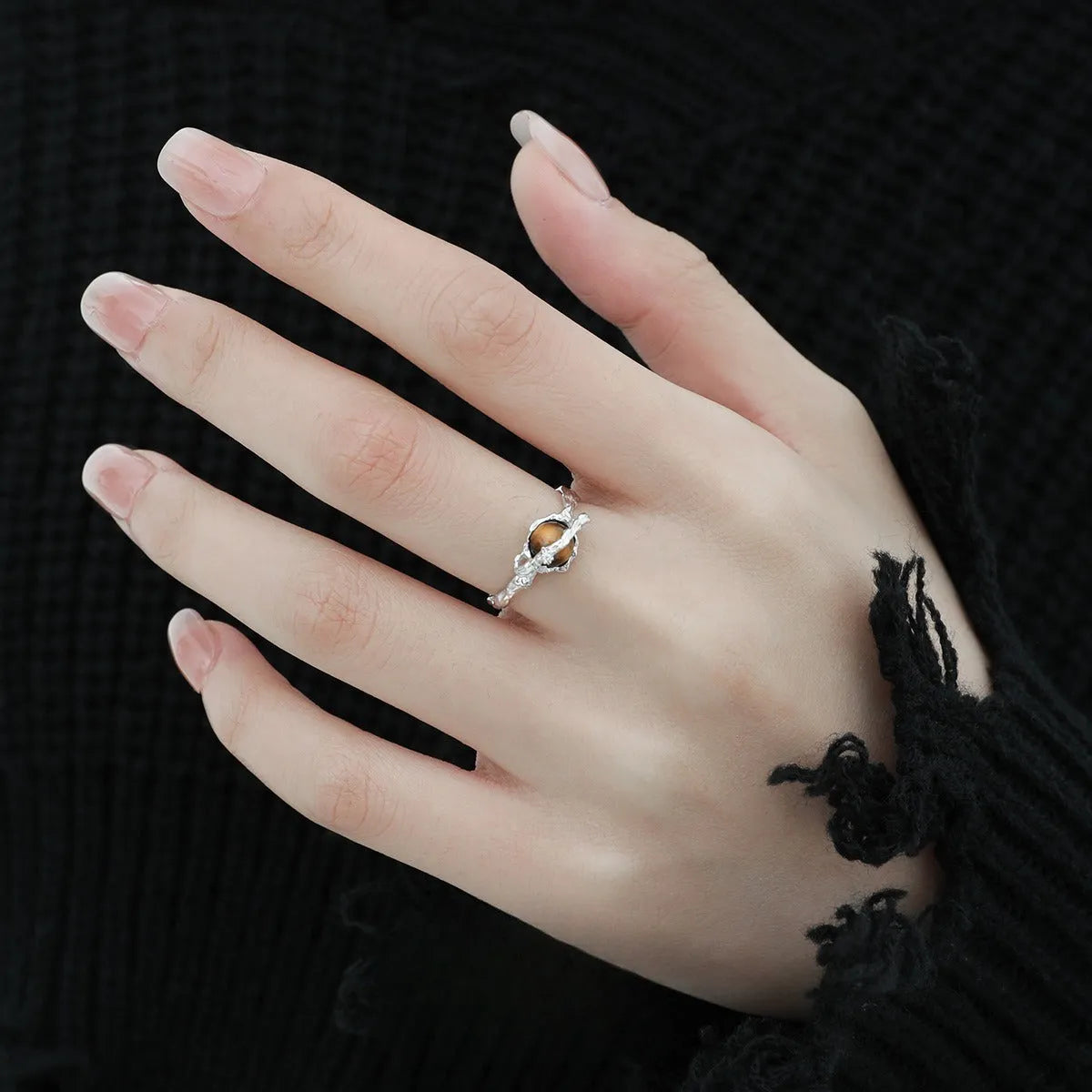 White gold colour Saturn open ring with adjustable opening on silver background