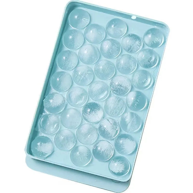 Large blue silicone ice cube tray with lid showing 33 round cavities.