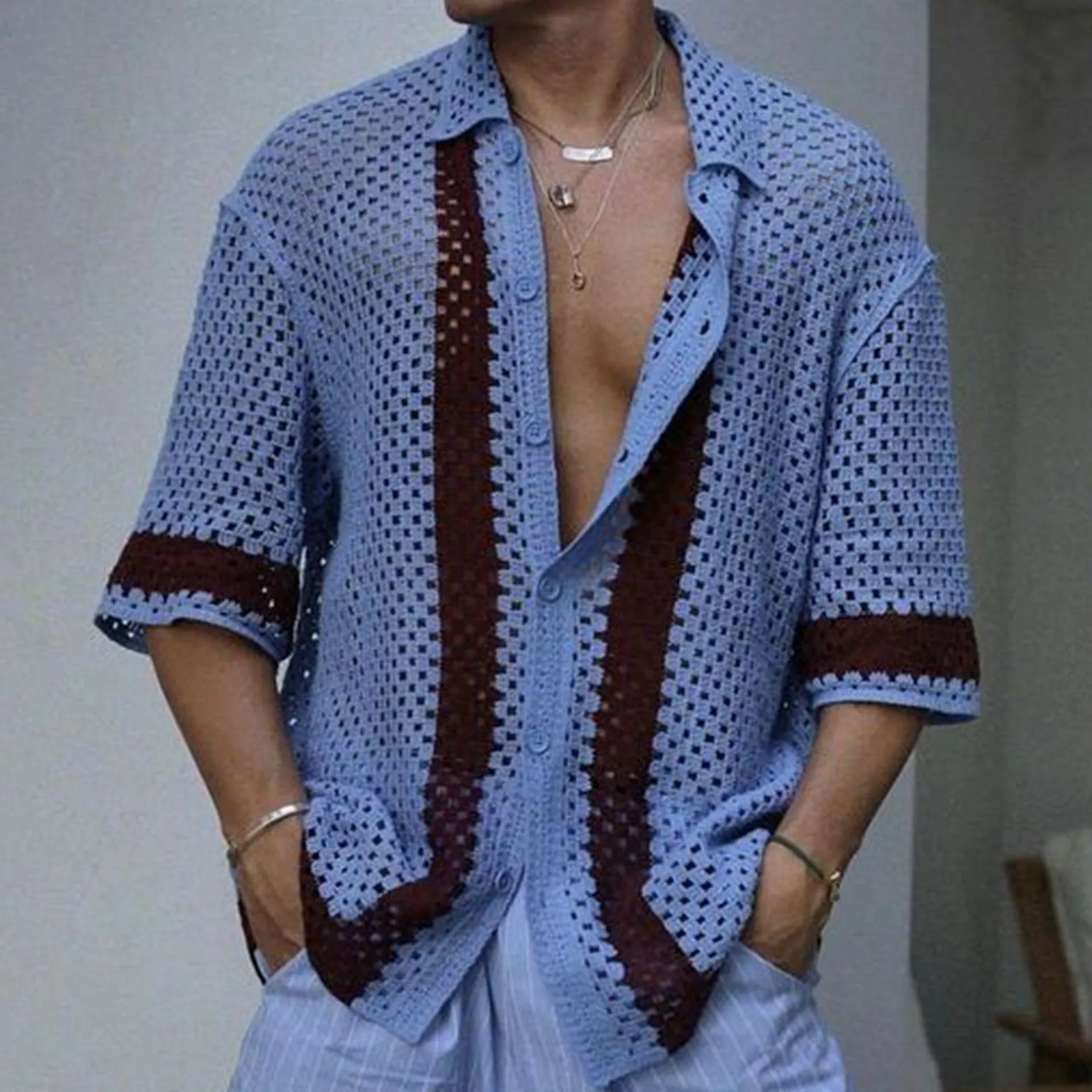 Men's blue hollow knit viscose cardigan with short sleeves and open front, shown on model