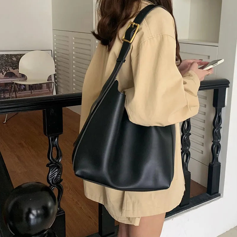 Women's solid colour PU leather shoulder bag in black, square vertical shape with sewing thread detail and single strap