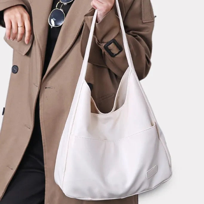Women's soft PU leather retro shoulder bag in black with single strap and open pocket.