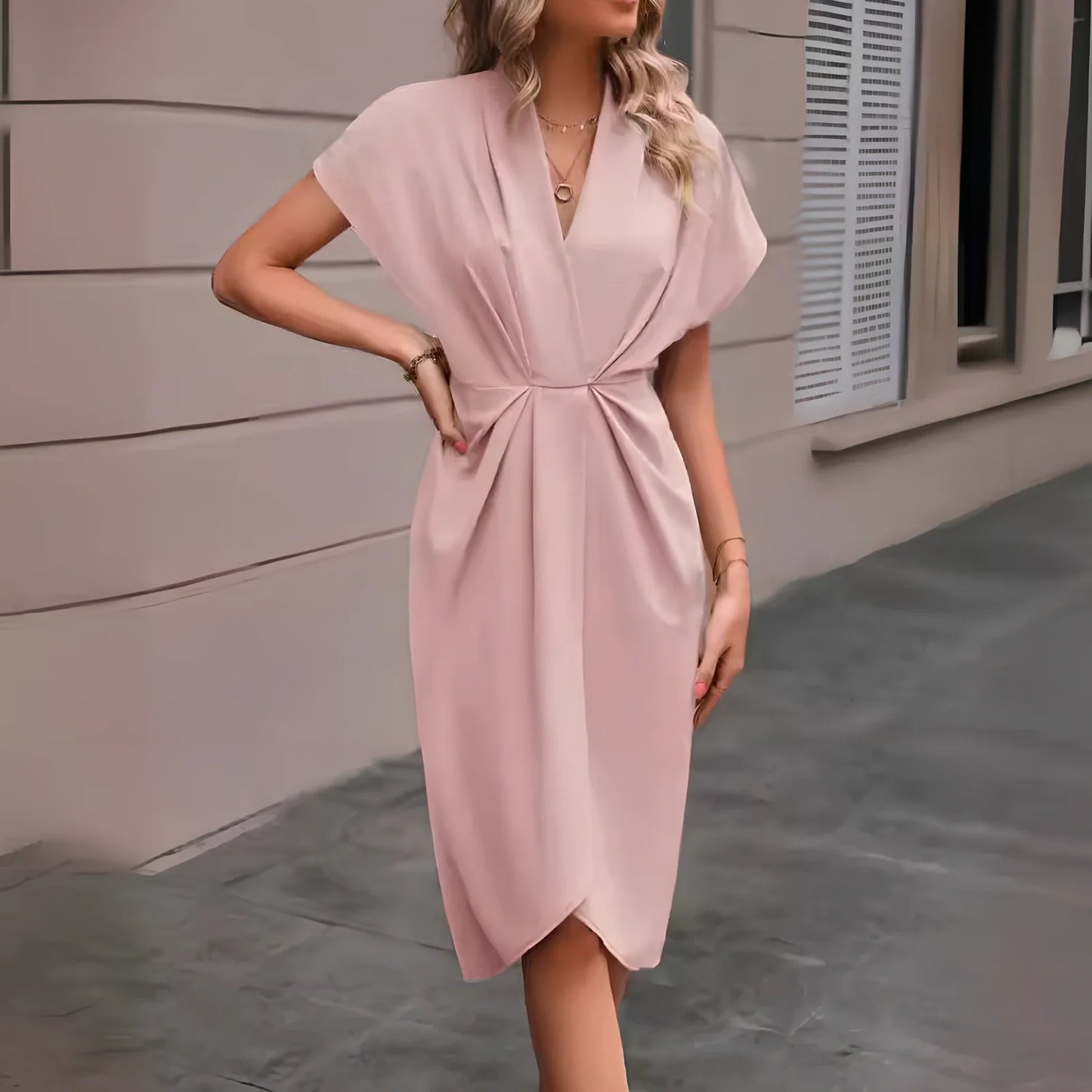 Black V-neck batwing sleeve polyester dress with pleated A-line skirt, mid-length 94cm in size M, showing shrug sleeves and solid colour fabric