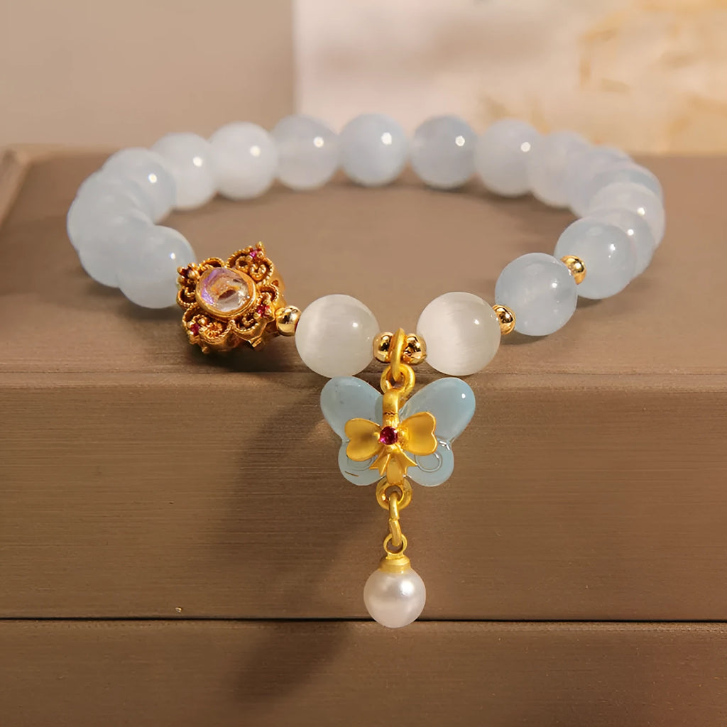 Women's aquamarine butterfly pendant crystal bracelet with rhinestone detailing on wrist