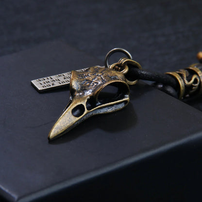 Retro leather rope keychain with lobster buckle and skull pendant in bronze and silver