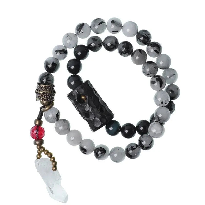 Ethnic style black hair bracelet with white crystal tassel showing bending and lacing construction details