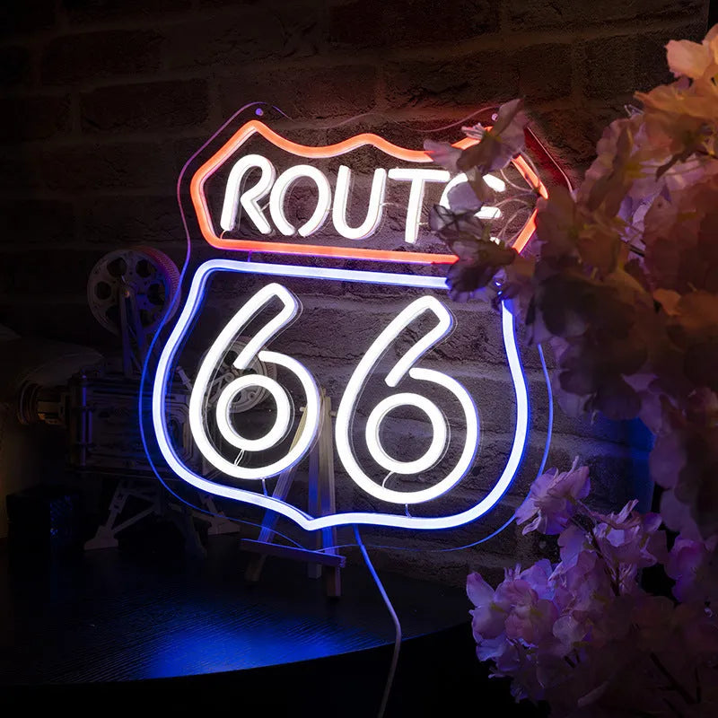 66 Highway LED neon word sign emitting warm white glow against a dark background