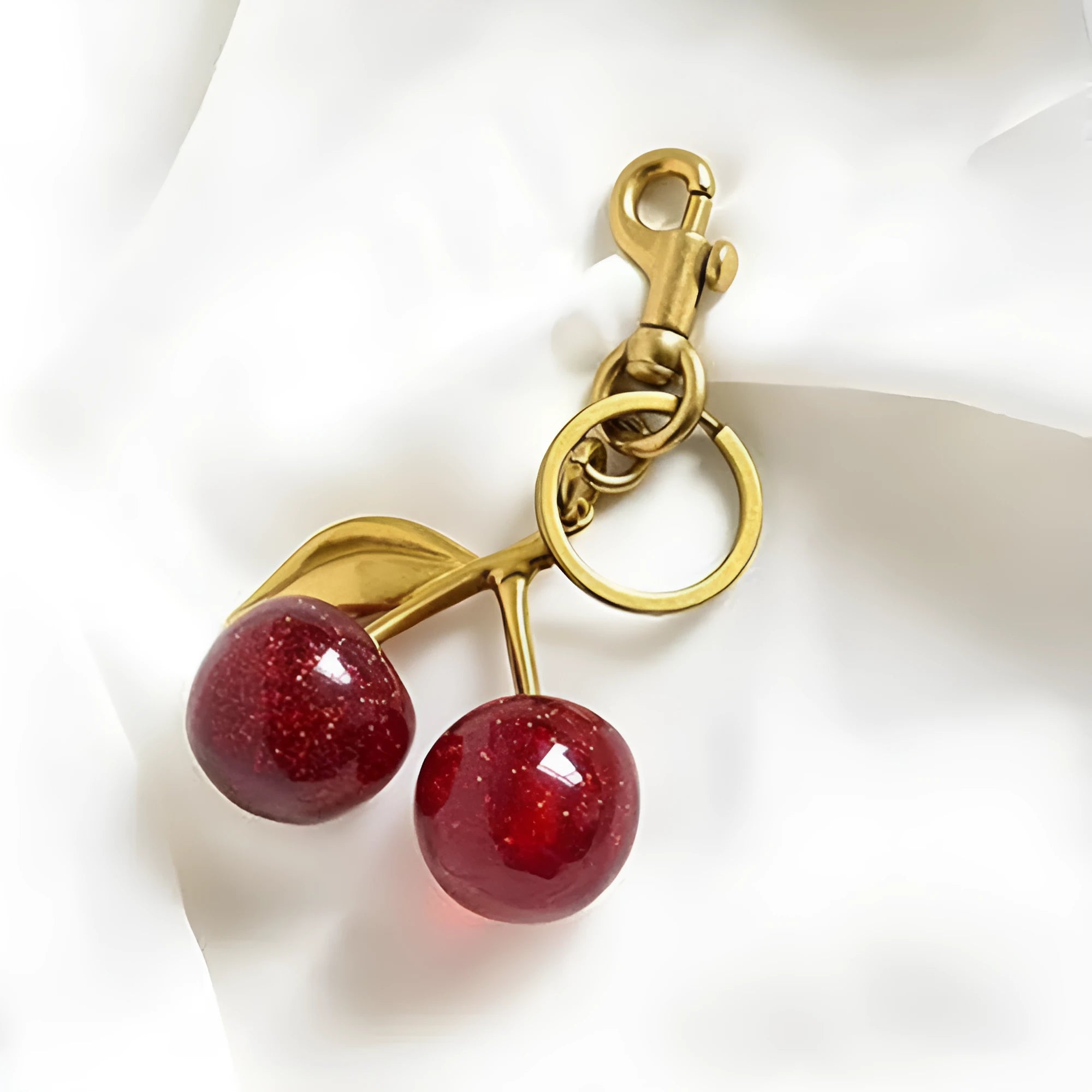 Red three-dimensional zinc alloy pendant for a keyring or women's bag.