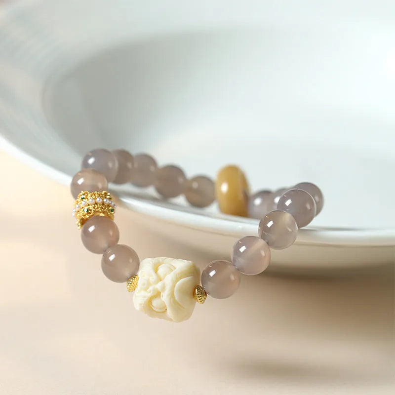 Grey agate melilite bracelet with 10mm round beads and hand-woven construction