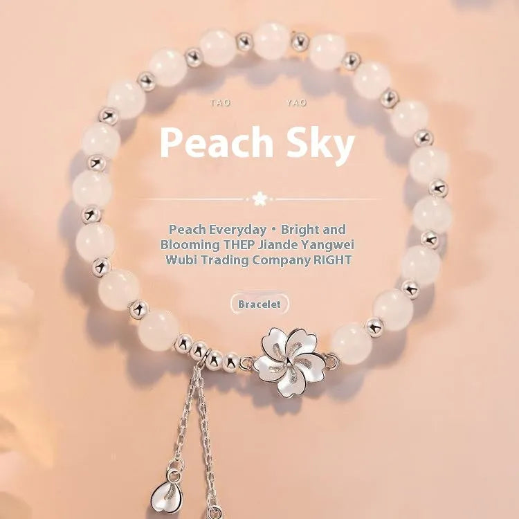 New Chinese style beaded bracelet with floral resin charms showing camellia, lotus and peach blossom designs