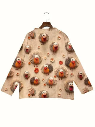 Loose-fit digital printed top with lapel collar on a hanger, showing graphic print design.