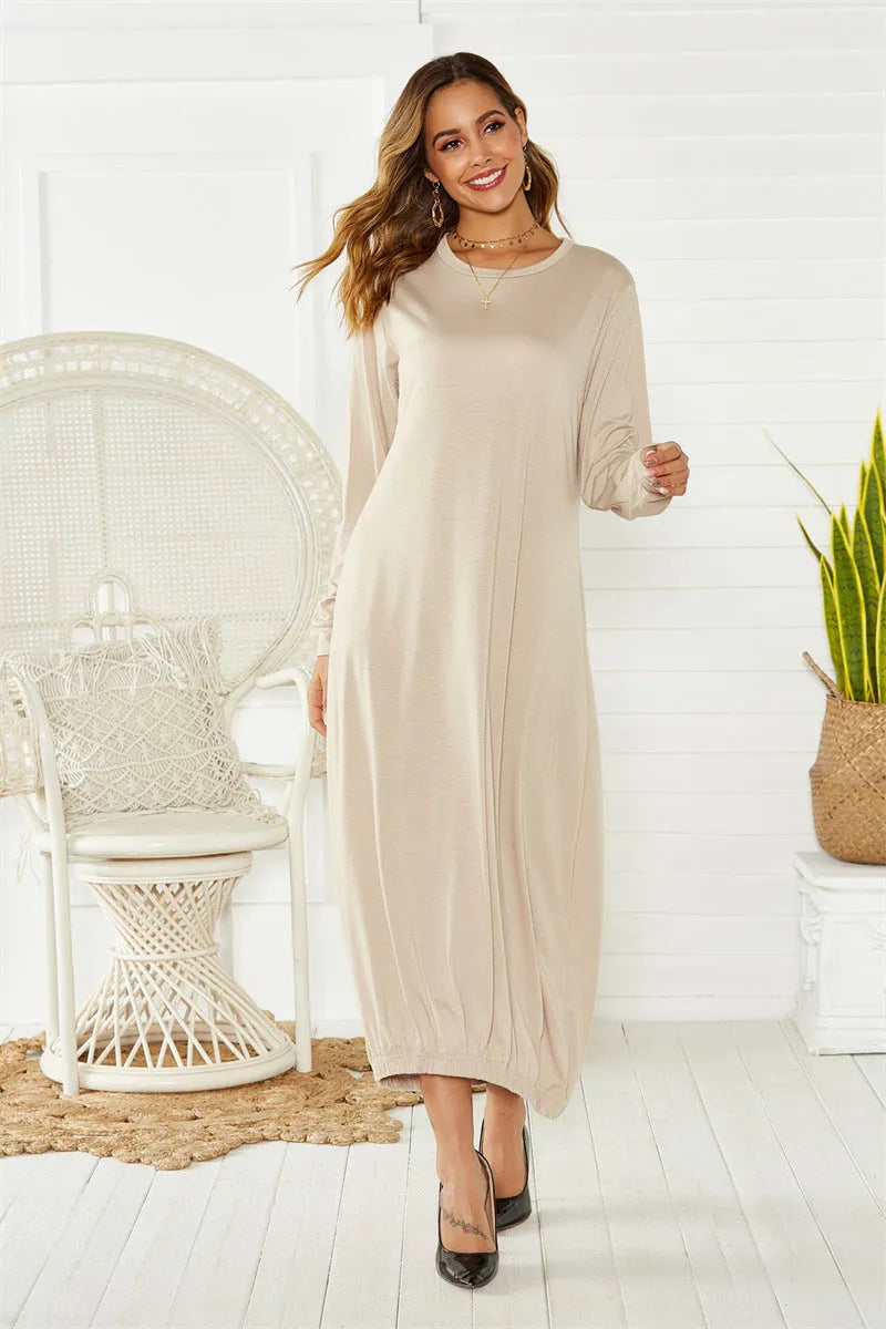A loose, black lantern-style dress with a lace-up detail on the crew neckline.