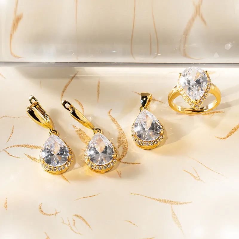 Drop-shaped zircon non-fading three-piece jewellery set gold plated with mixed gem inlaid pendant in emerald gold colour on white background