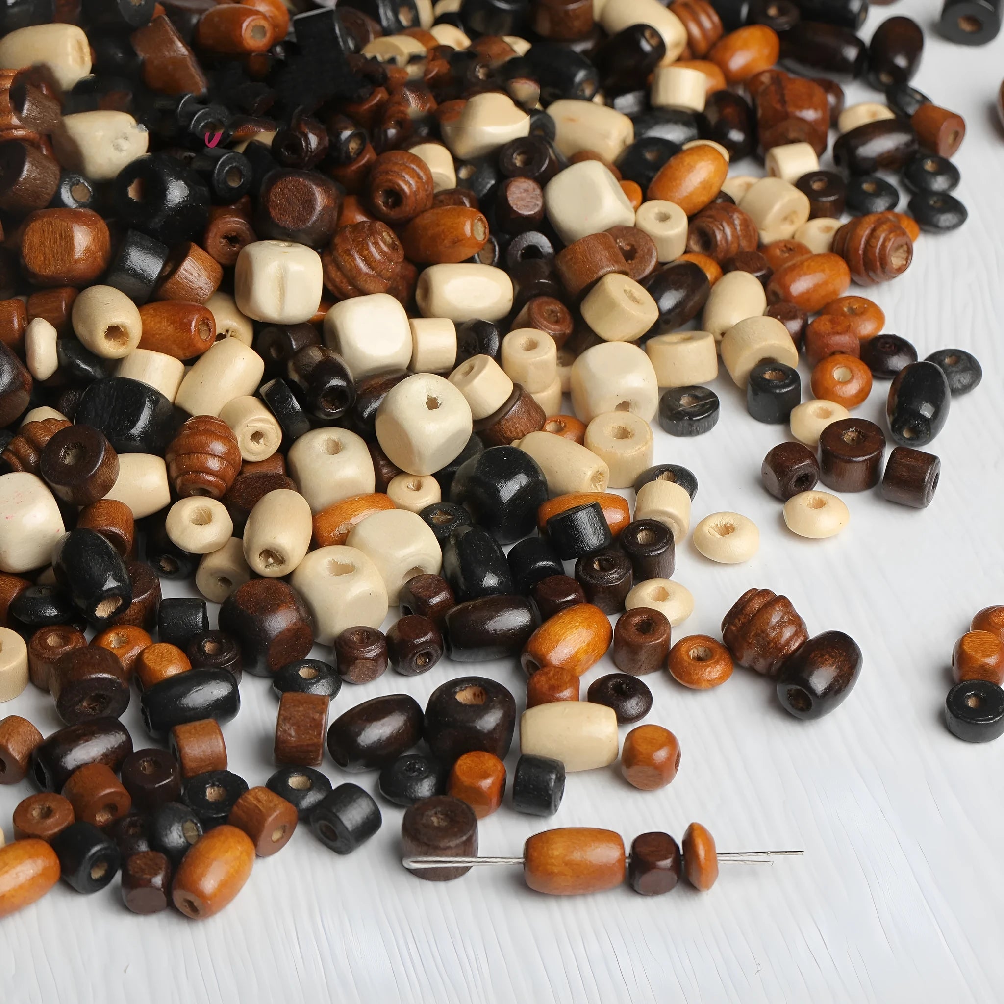 Scattered vintage solid wood beads in mixed colours for DIY jewellery making.
