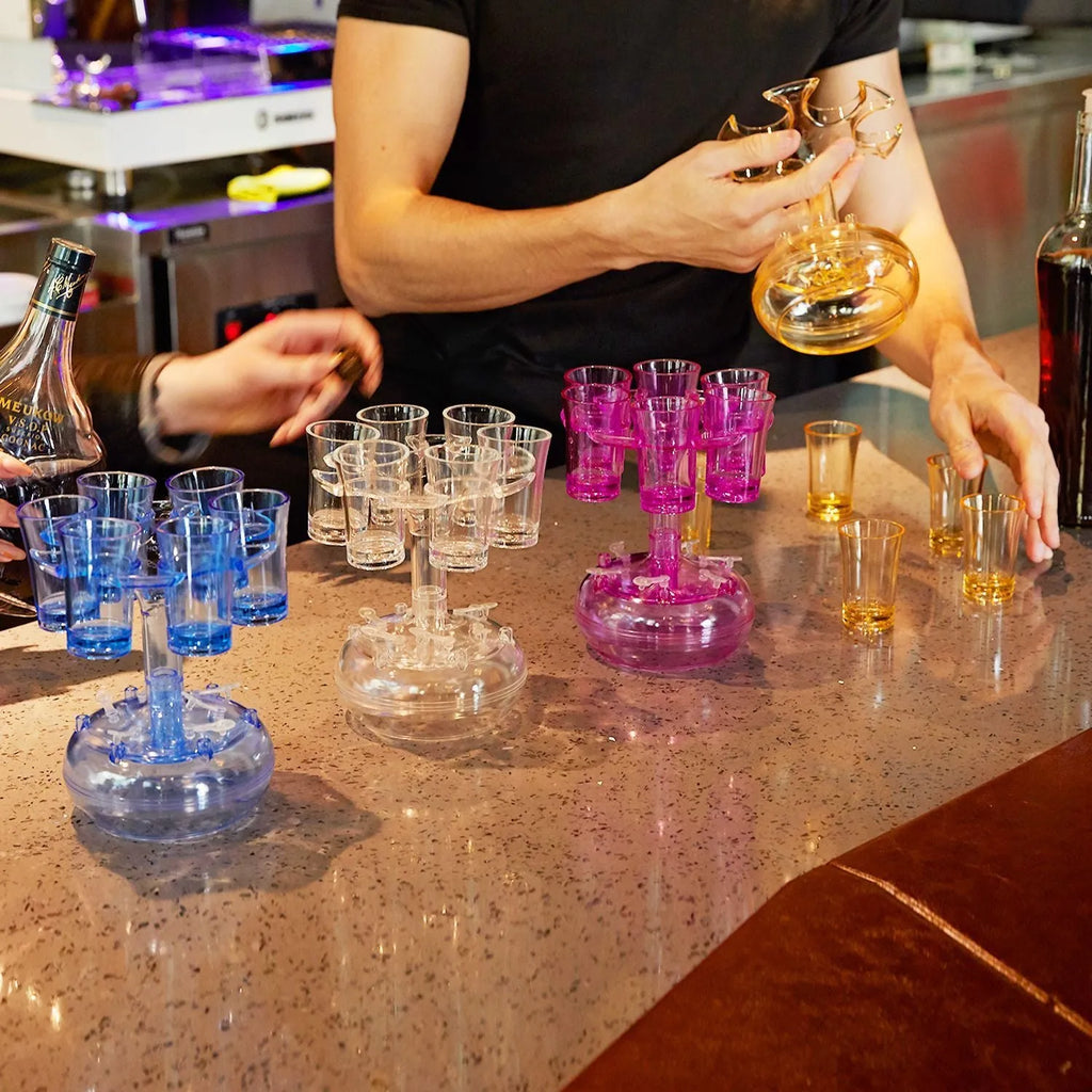 Clear six-shot glass dispenser rack holding six shot cups, bar accessory for parties.