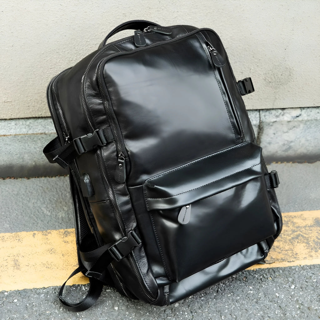 Large capacity genuine leather backpack in black, 30x20x45cm, with curved shoulder strap and retro design