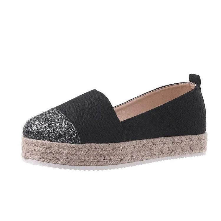 Black plus size breathable canvas flat shoe with round toe and slip-on design.